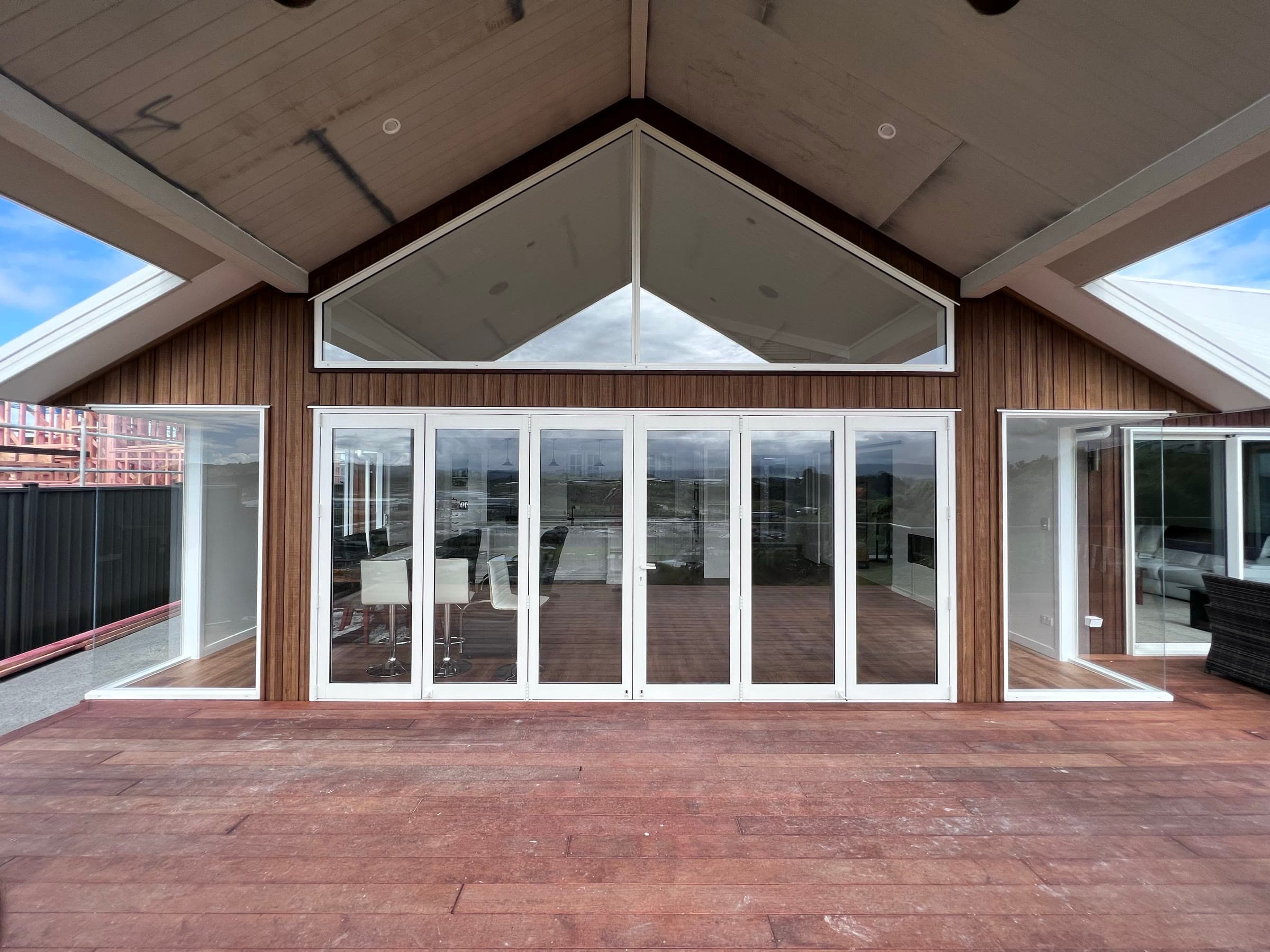 The finished home: a kwila deck, bifold doors and a glass gable